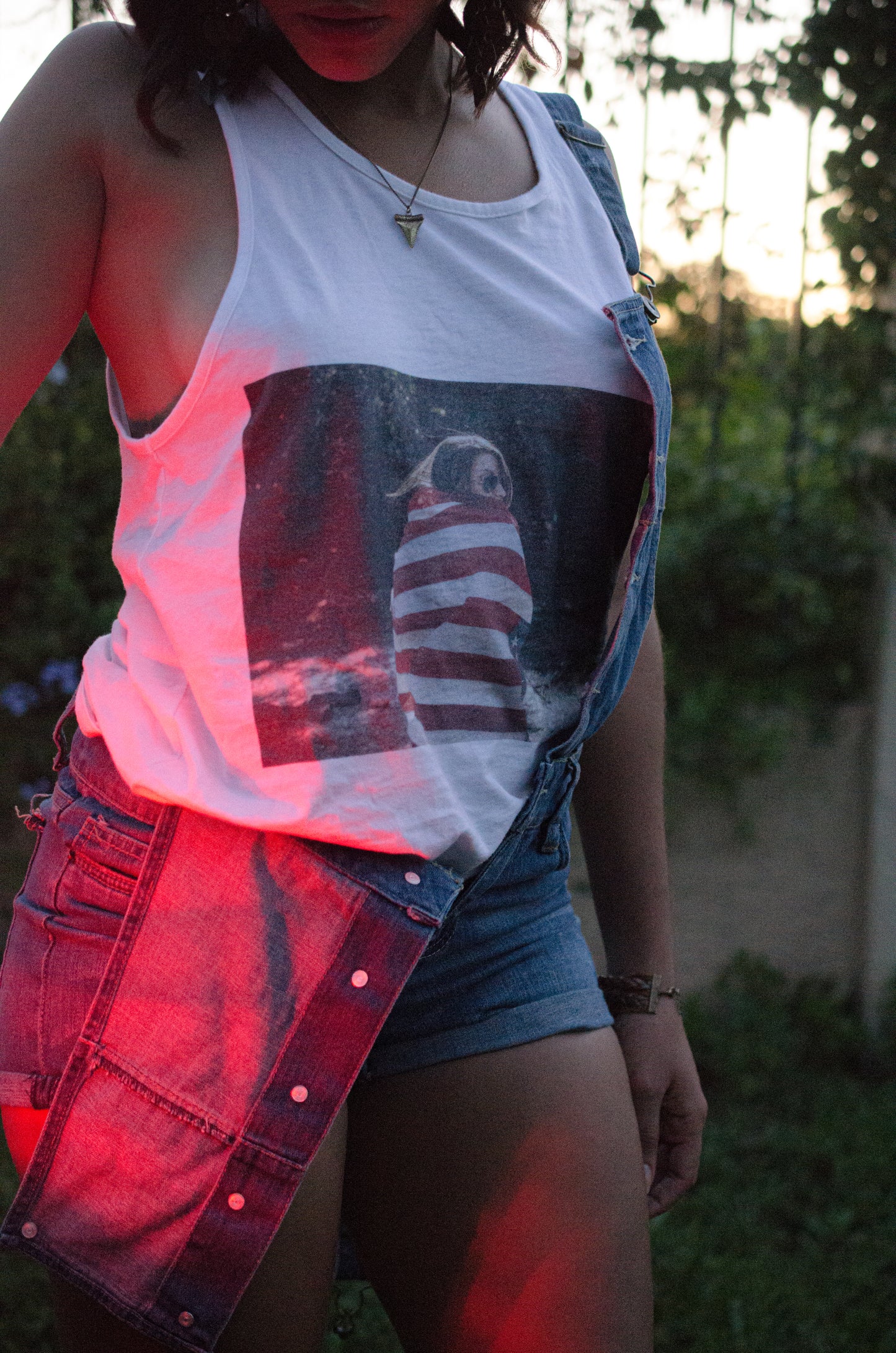 A girl wearing KennyPierrelus Tank Top with centered american flag 